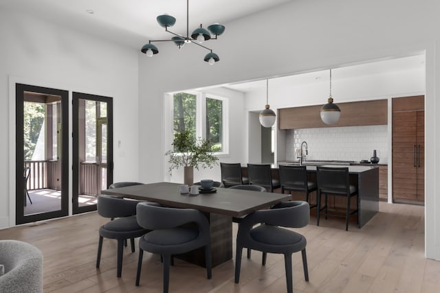 dining space featuring a notable chandelier and light hardwood / wood-style floors