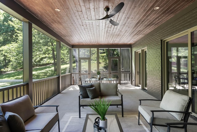 sunroom / solarium with wood ceiling, ceiling fan, and a healthy amount of sunlight