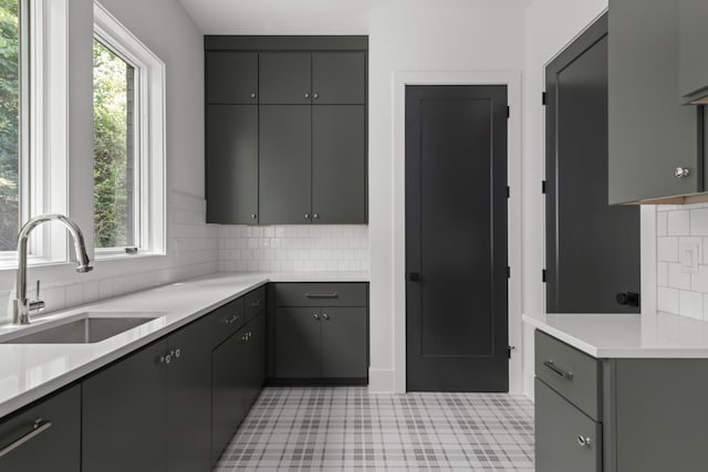 kitchen featuring gray cabinetry, plenty of natural light, and sink