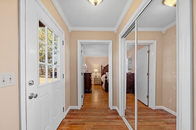 doorway to outside with light hardwood / wood-style floors and ornamental molding