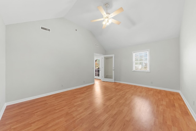 unfurnished room featuring ceiling fan, french doors, light hardwood / wood-style floors, and vaulted ceiling