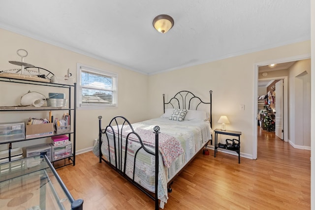 bedroom with hardwood / wood-style floors and ornamental molding