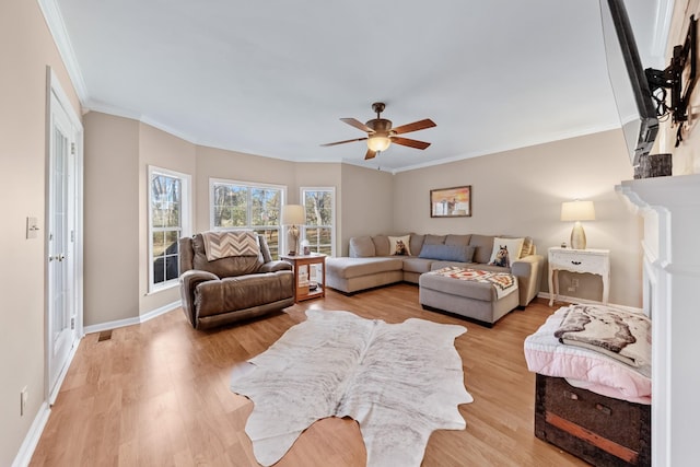 living room featuring ceiling fan, light hardwood / wood-style floors, and ornamental molding