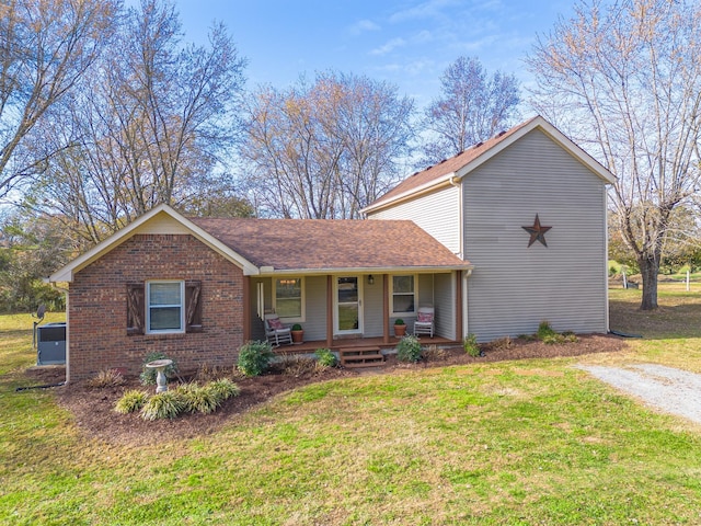 ranch-style home with a front yard and a porch