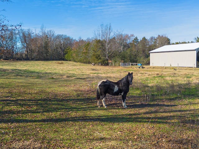 view of yard featuring an outbuilding and a rural view