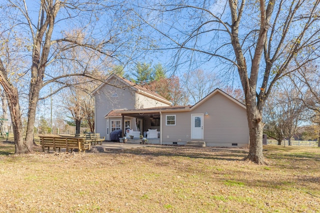 back of house with a patio area, ceiling fan, and a yard