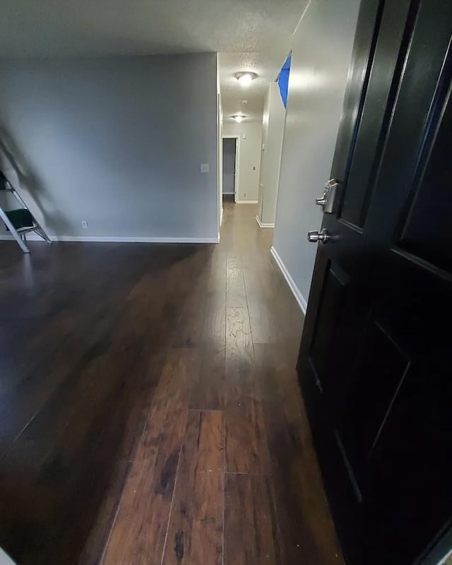 hall with dark wood-type flooring