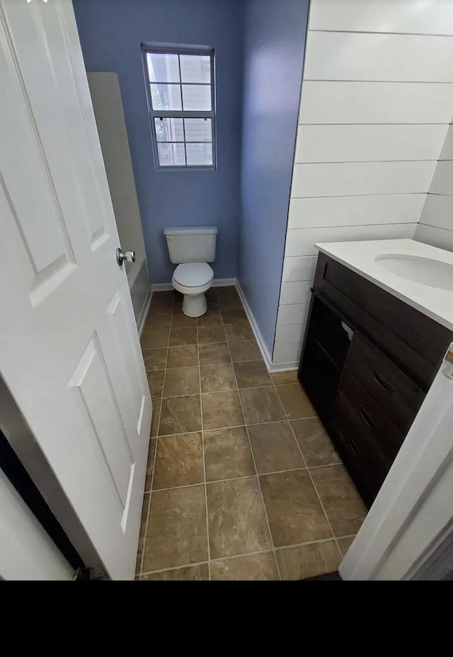 bathroom with tile patterned floors, vanity, and toilet