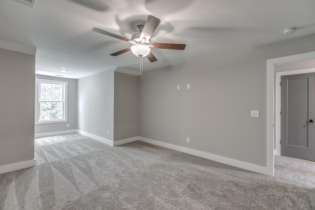 empty room featuring ceiling fan and light carpet