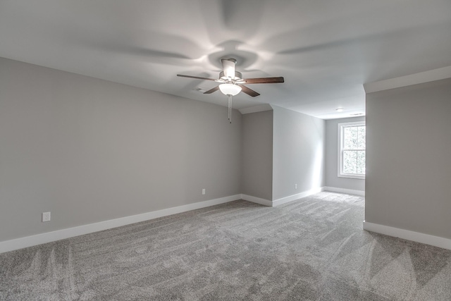 carpeted spare room with ceiling fan