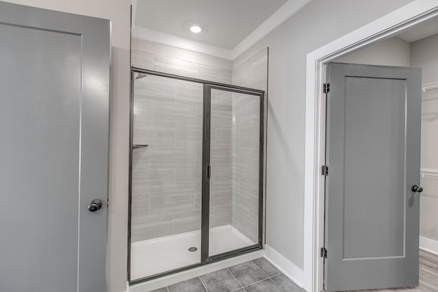 bathroom featuring tile patterned flooring and an enclosed shower