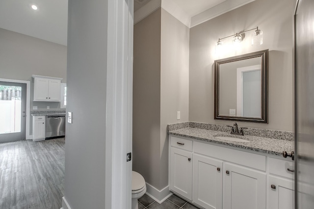 bathroom with hardwood / wood-style flooring, vanity, toilet, and crown molding