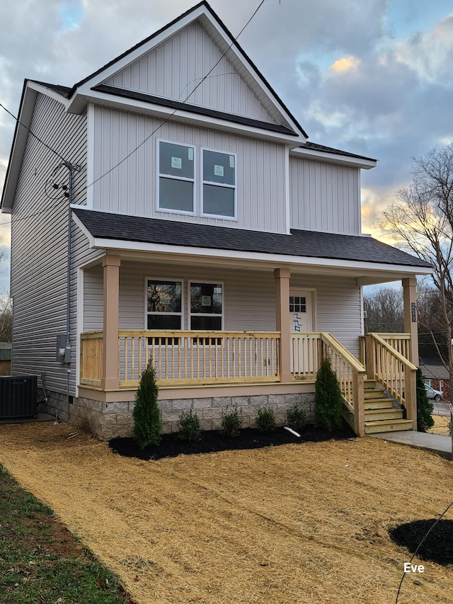 view of front of home with a porch and central AC unit