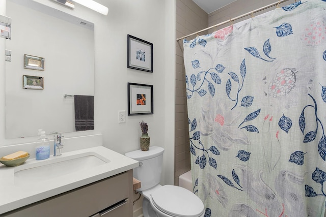 bathroom featuring vanity, toilet, and walk in shower