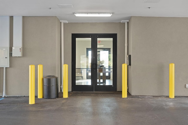 garage featuring electric panel and french doors