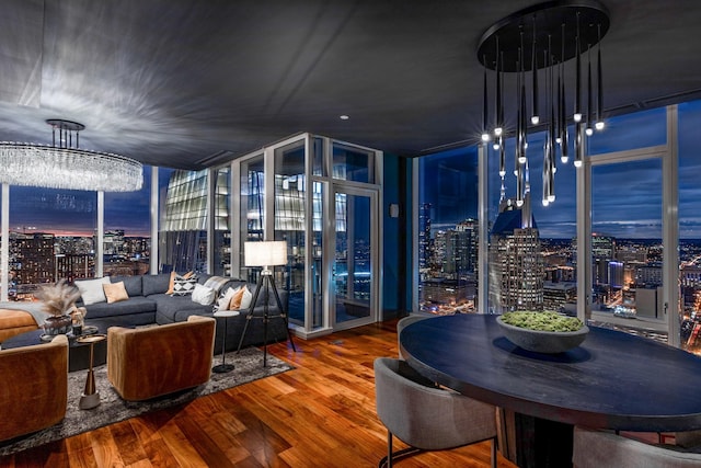 dining space with hardwood / wood-style floors and floor to ceiling windows