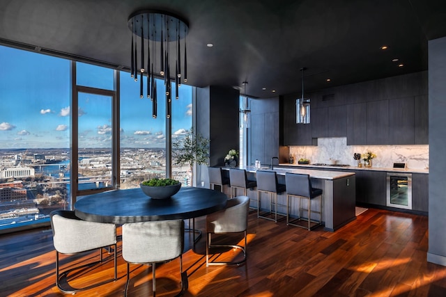 dining area featuring plenty of natural light, beverage cooler, dark hardwood / wood-style floors, and sink