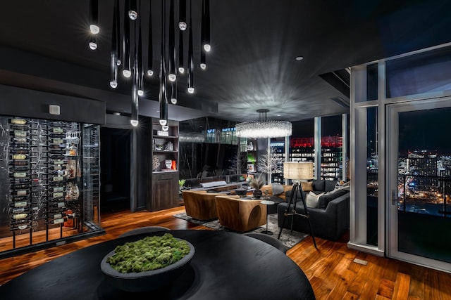 interior space with wood-type flooring, electric panel, and an inviting chandelier