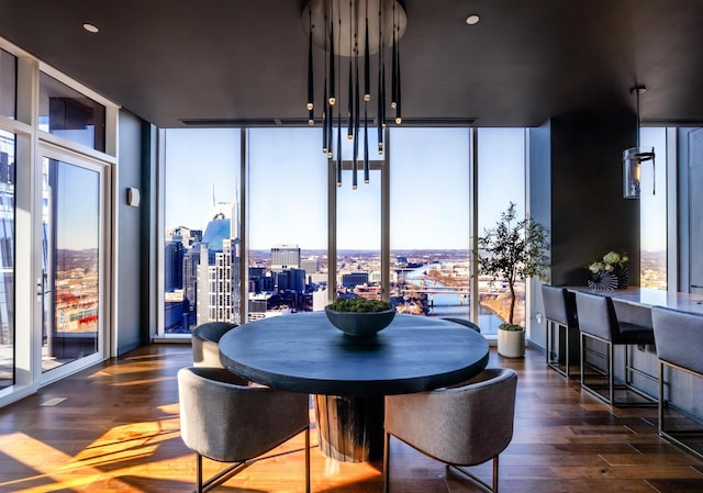 dining area with floor to ceiling windows and dark wood-type flooring