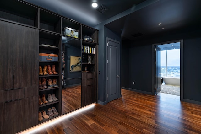 unfurnished room with dark wood-type flooring