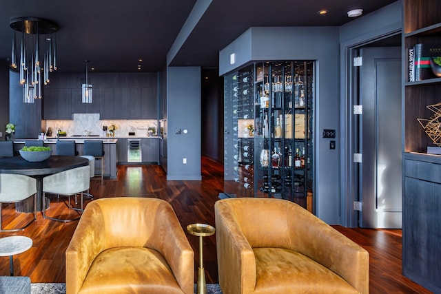 bar featuring pendant lighting, dark hardwood / wood-style flooring, and backsplash