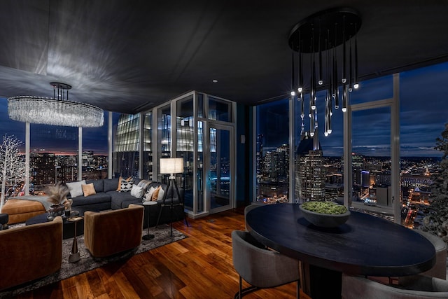 interior space with hardwood / wood-style flooring, an inviting chandelier, and a wall of windows