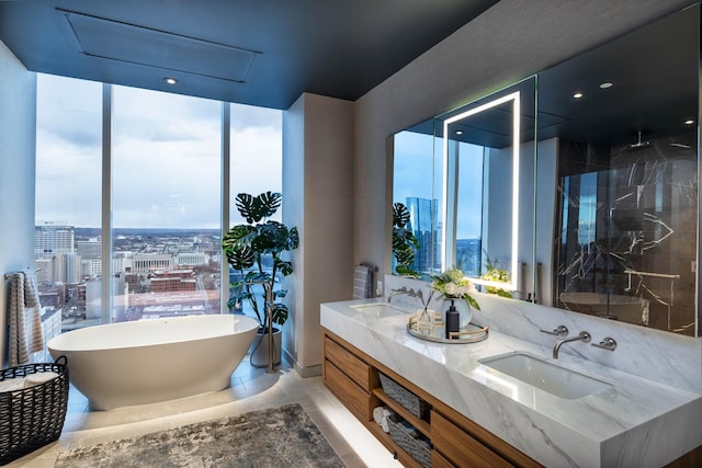 bathroom featuring tile patterned flooring, shower with separate bathtub, vanity, and a healthy amount of sunlight