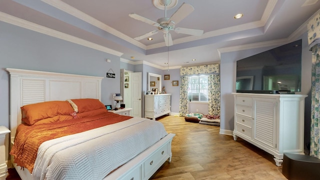 bedroom featuring a raised ceiling, ceiling fan, and ornamental molding