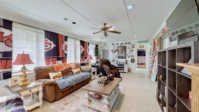 living room with ceiling fan and crown molding