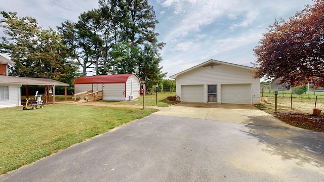 exterior space featuring a garage, a carport, and an outdoor structure