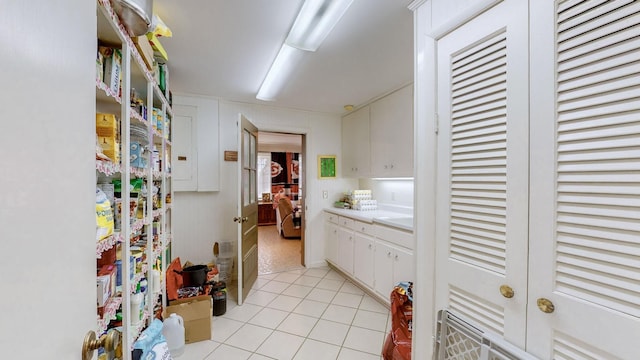 kitchen with white cabinets and light tile patterned floors