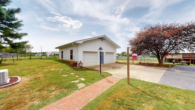 view of home's exterior featuring a lawn, a garage, and an outdoor structure