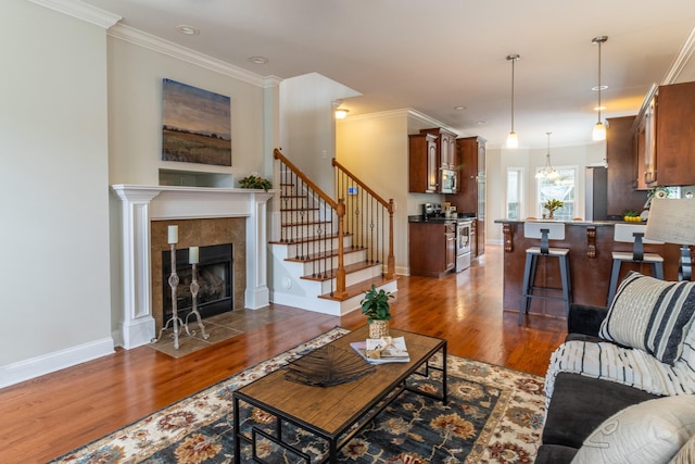 living room with a fireplace, dark hardwood / wood-style flooring, and ornamental molding