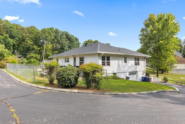 view of side of home featuring a yard and a garage