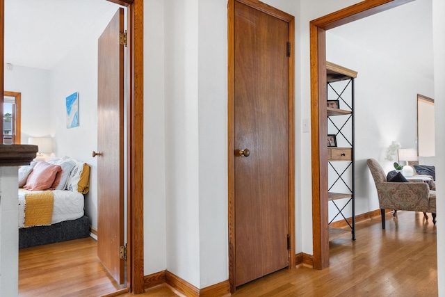 corridor with light hardwood / wood-style flooring