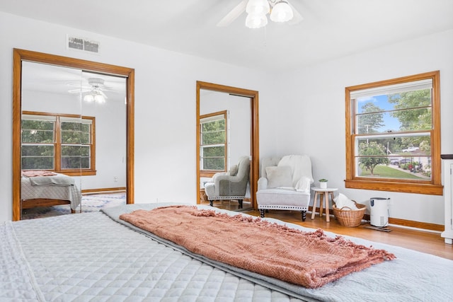 bedroom with a closet, hardwood / wood-style flooring, and ceiling fan