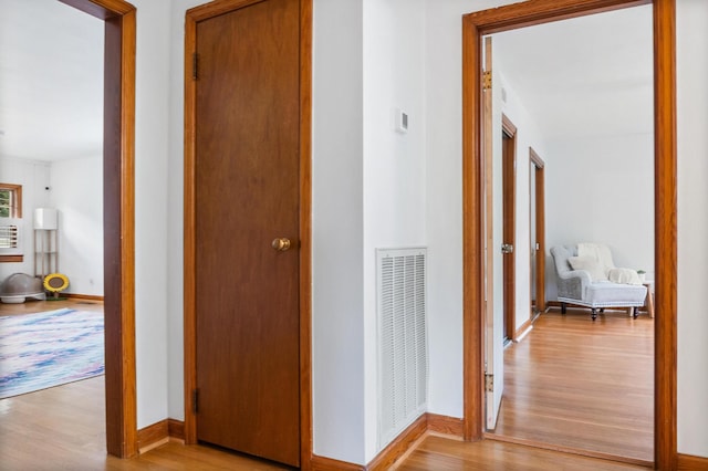 hallway with light hardwood / wood-style flooring