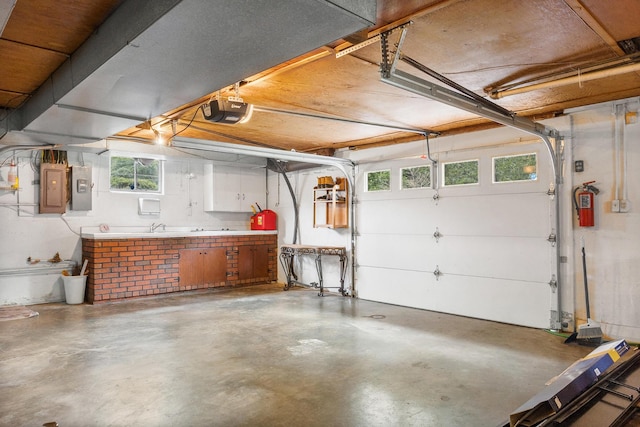 garage with electric panel and a garage door opener