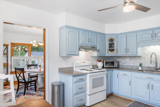 kitchen featuring light hardwood / wood-style floors, electric stove, sink, and dark stone counters