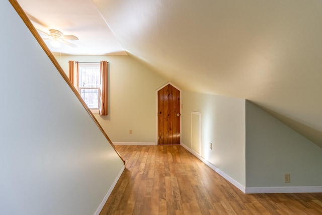 bonus room with lofted ceiling, ceiling fan, and light wood-type flooring