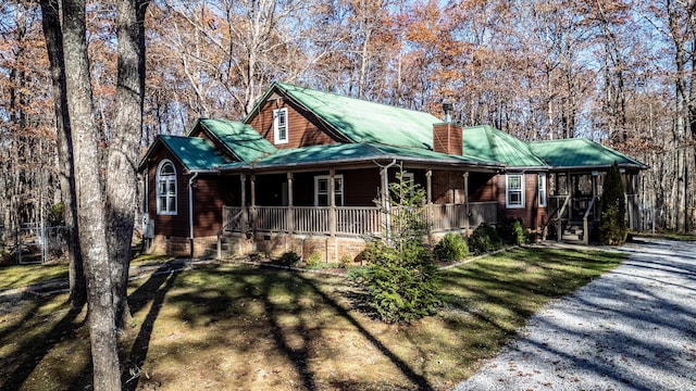 view of front of home featuring covered porch and a front yard