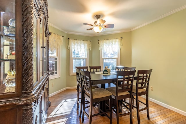 dining room featuring ceiling fan, hardwood / wood-style floors, and ornamental molding