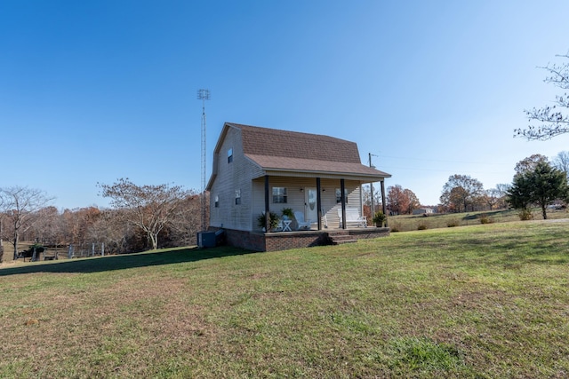 exterior space with a front lawn, central AC unit, and a porch