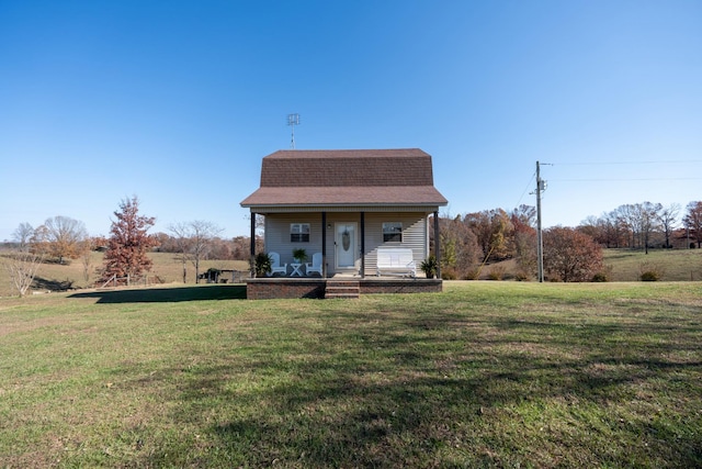 view of front of home featuring covered porch and a front lawn