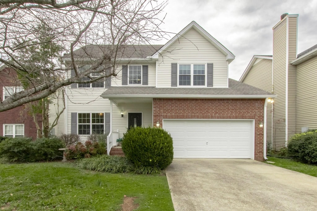 view of front facade with a garage and a front lawn