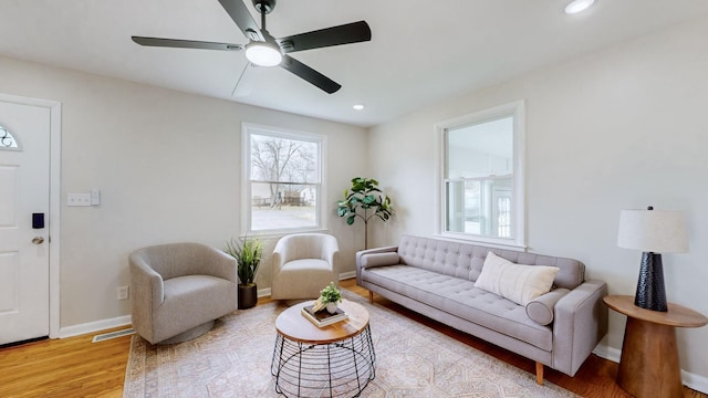 living room featuring ceiling fan and light wood-type flooring