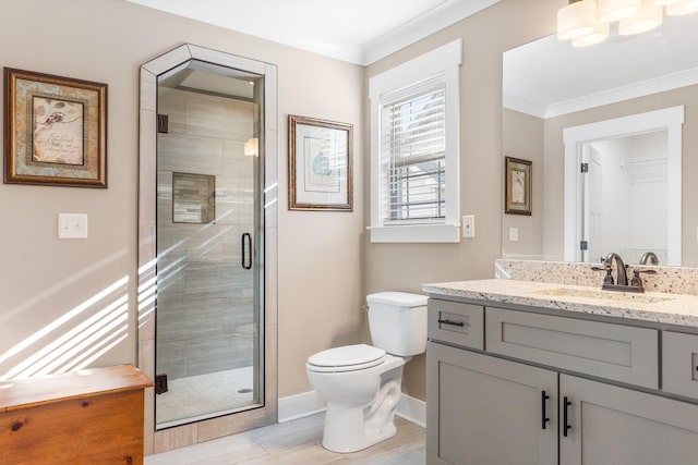 bathroom featuring hardwood / wood-style flooring, vanity, a shower with shower door, and ornamental molding