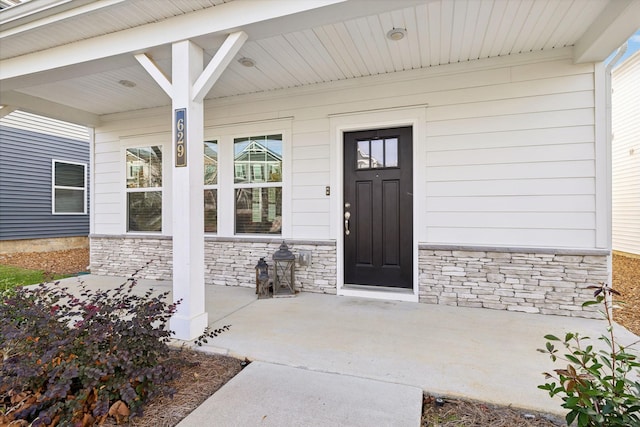 doorway to property featuring a porch