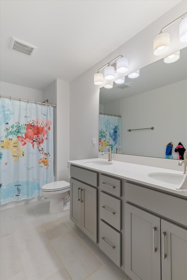 bathroom featuring tile patterned floors, vanity, a shower with shower curtain, and toilet