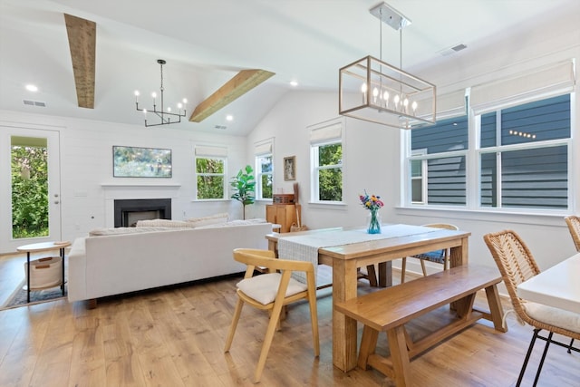 dining space featuring light hardwood / wood-style flooring and lofted ceiling